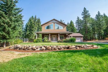 Two-story home surrounded by evergreen trees