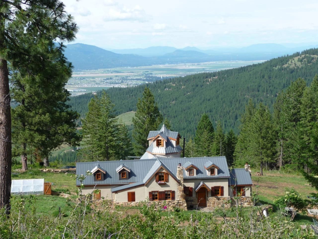 Mountain lodge with stone walls in forested valley
